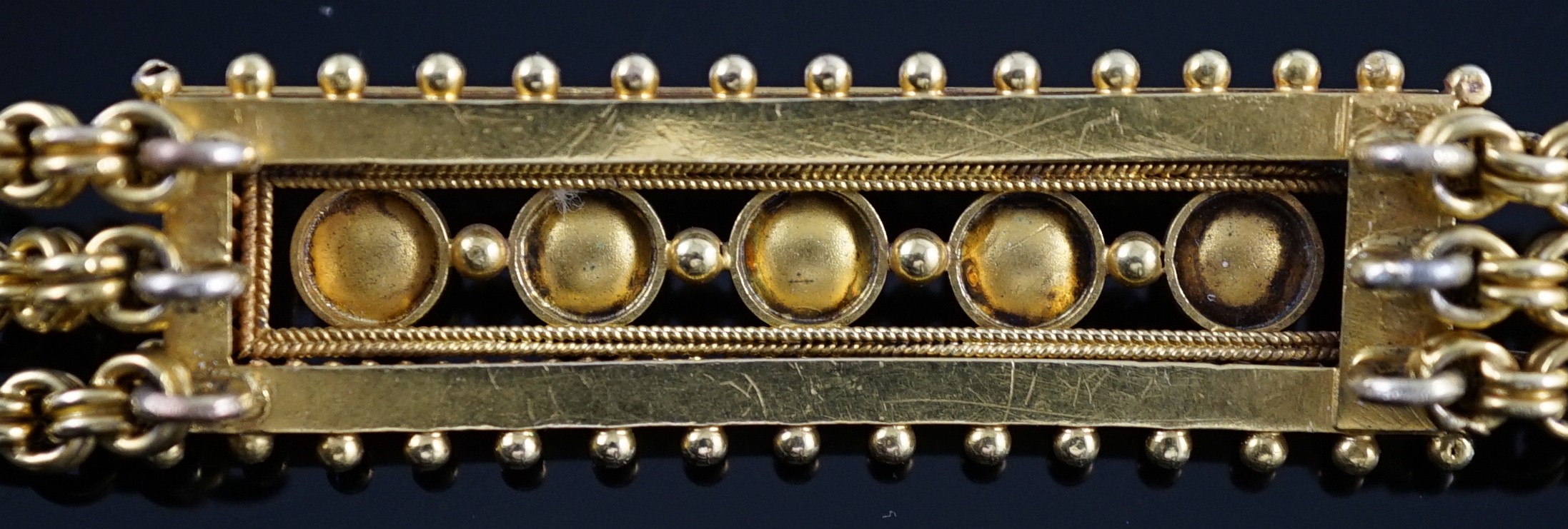 An early 20th century triple strand gold bracelet with central rectangular motif set with five cultured pearls